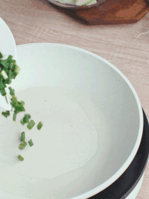 熱油下臘肉、蔥花煸炒，再下西葫蘆。